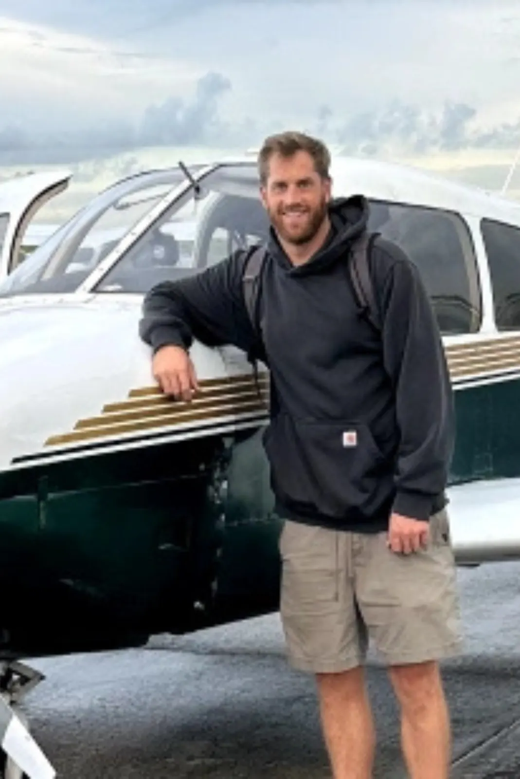 Airline Pilot Program student pilot in uniform beside a Flight Time training aircraft — $125,800 all-inclusive package