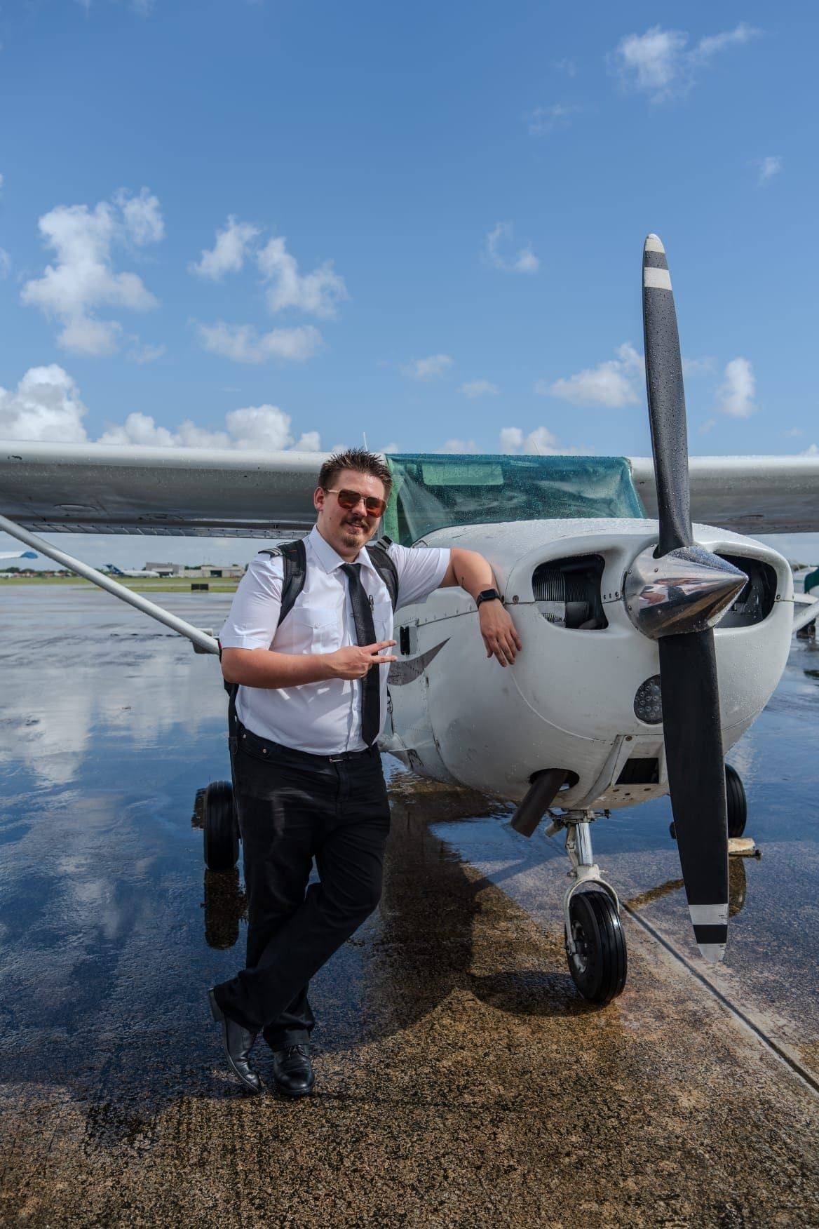 Commercial pilot student briefing a cross-country flight beside a My Flight Time Cessna 172 at KFXE